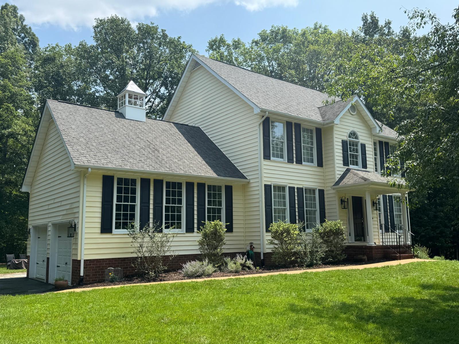Clean siding home with dark shutters