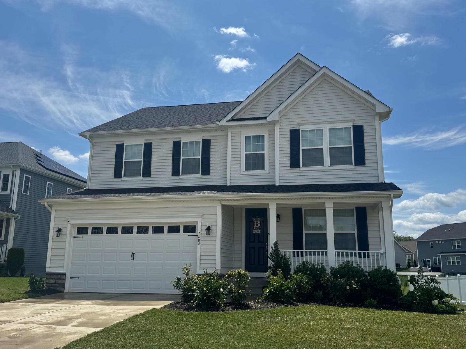 Clean brick home with maroon shutters