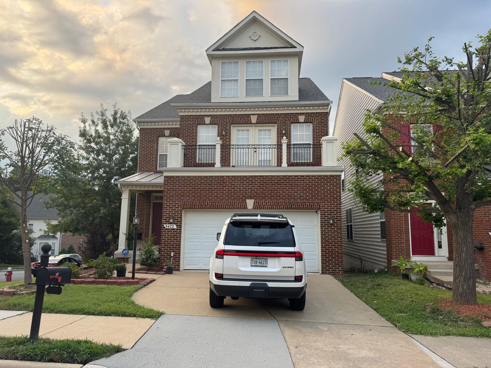 Clean three-story brick home with balcony