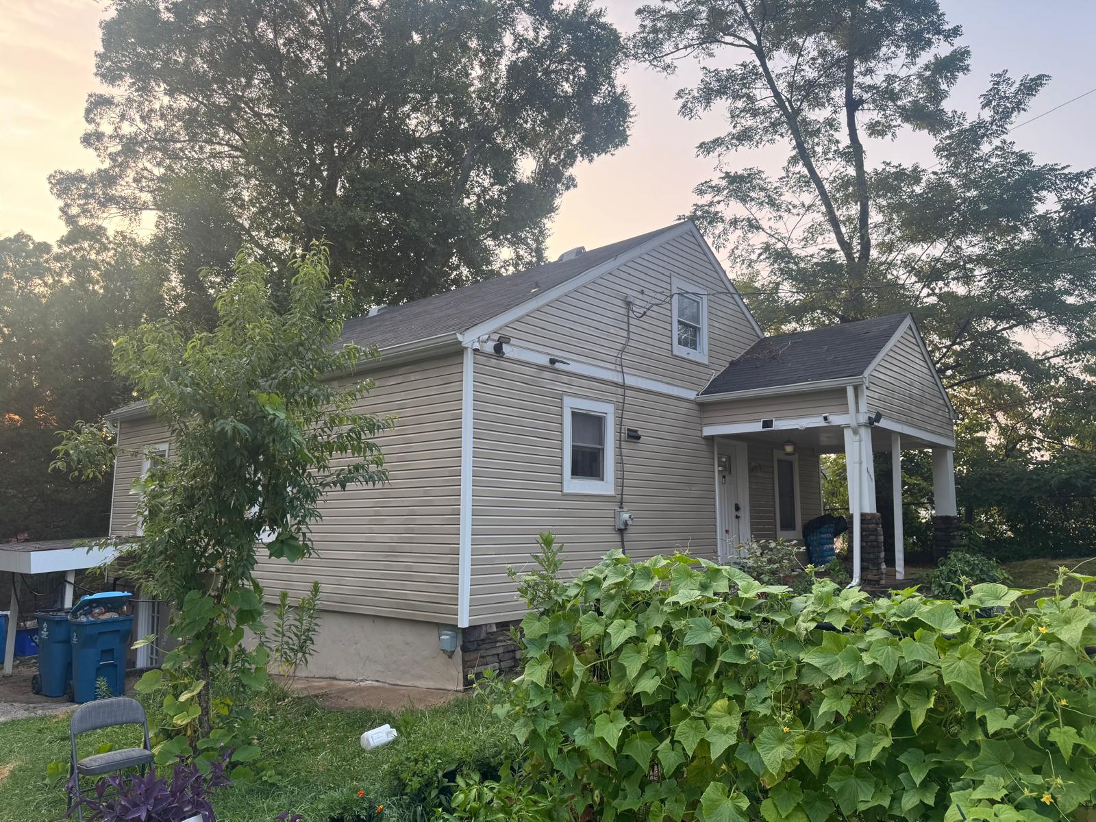 Clean tan vinyl siding home at dusk